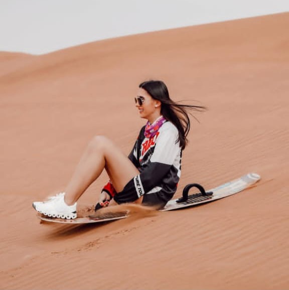 Sandboarding activity down the high Erg Chebbi dunes in Morocco