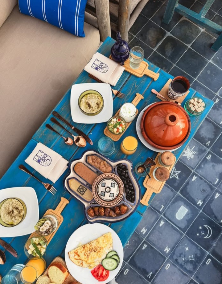 Traditional Moroccan food table with Tagine and appetizers - authentic culinary guide