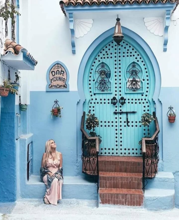 Luxury Morocco travel experience featuring traditional architecture and blue doors